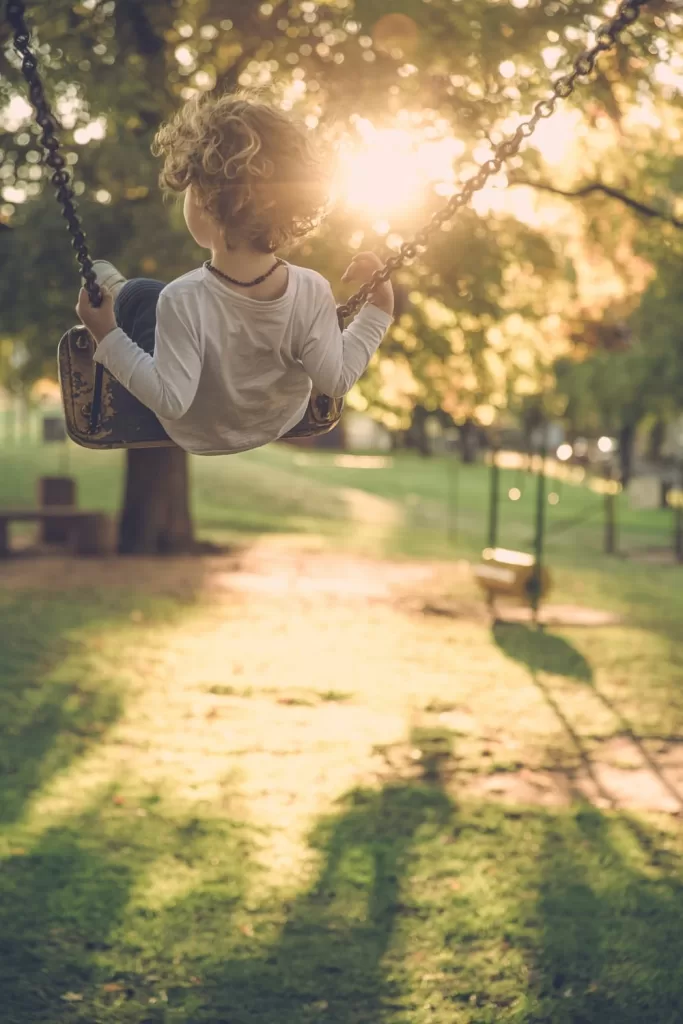 A young boy on a swing.