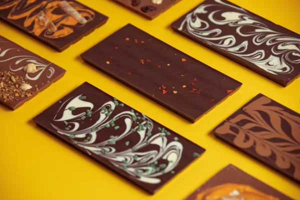 Chocolate bars are displayed on a yellow background.