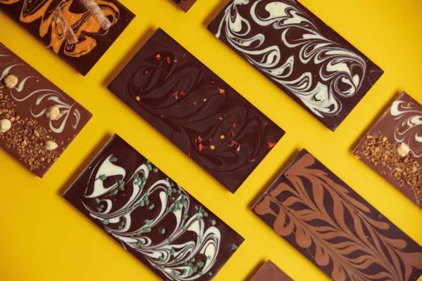 A selection of Wild Irish Chocolates bars on a yellow countertop.