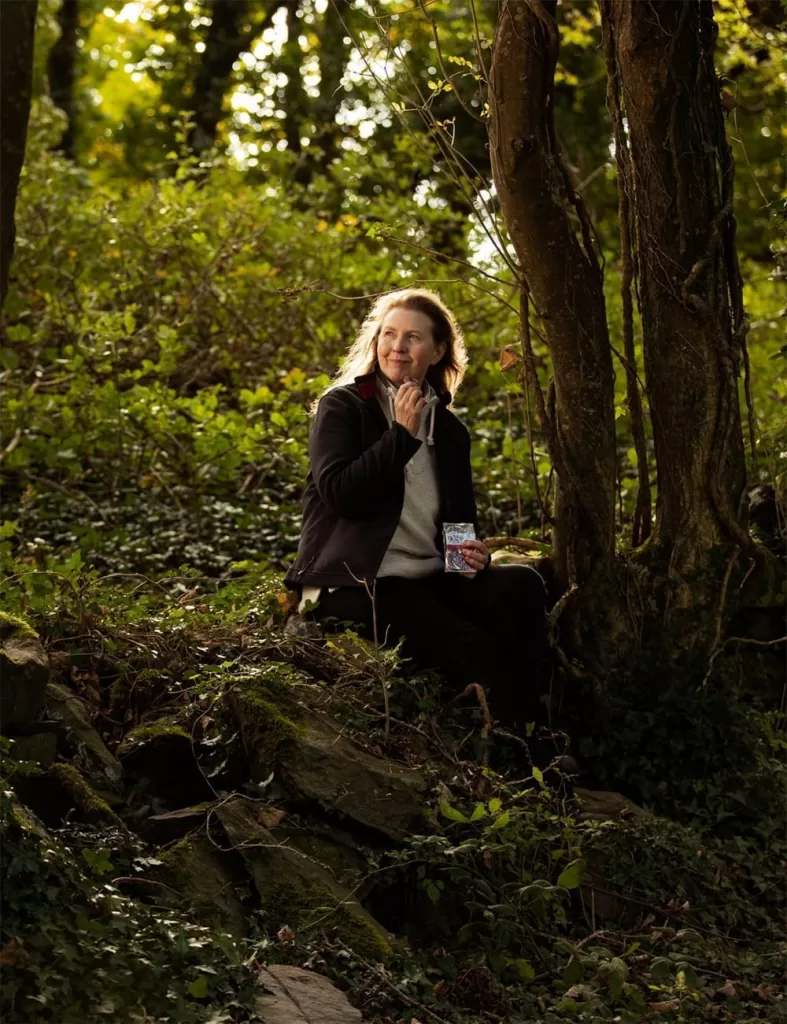 Patricia Farrell of Wilde Irish Chocolates sits in the woods near her home in Tuamgraney.