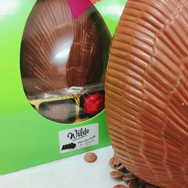 Milk Chocolate Truffle Egg displayed beside its green packaging.