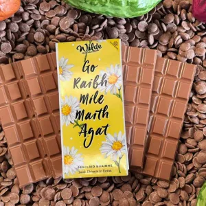 Irish language chocolate gift bar framed by milk chocolate bars and chocolate buttons