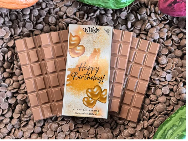 Happy Birthday Golden Hearts Chocolate Gift Bar on bed of chocolate bars