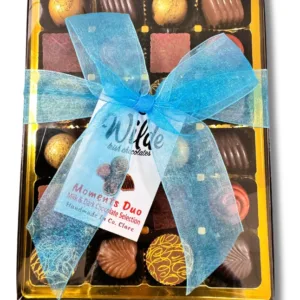 Large Box of 24 Decorated milk and dark chocolates in a box tied with a blue ribbon bow and a gold interior