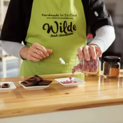 An employee prepares some products to display at the Chocolate Factory.